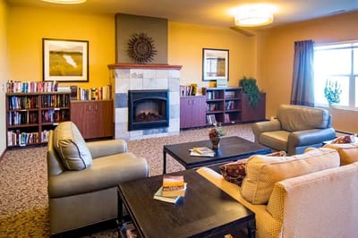 Cozy common area featuring seating and bookshelves