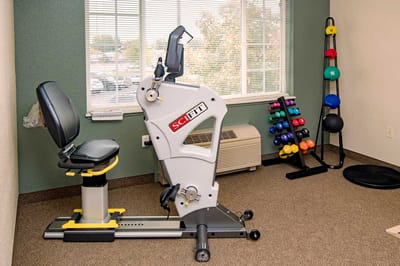 Exercise equipment in a well-lit therapy room