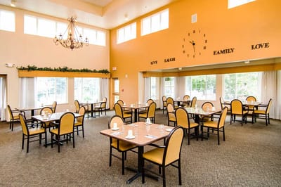 Dining area with tables and chairs in a warm-colored room