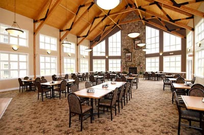 Dining room with tables and chairs in bright interior
