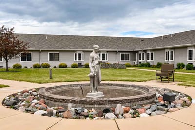 Outdoor courtyard with a statue and seating