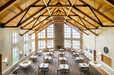 Spacious dining area with high ceilings and large windows
