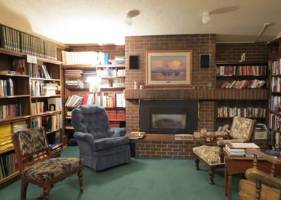 Cozy library area with bookshelves and seating
