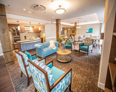 Common area with seating and kitchen in the background