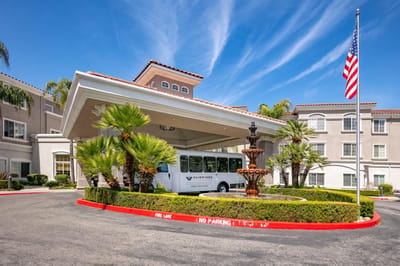 Entrance of Fairwinds Woodwark Park with fountain and shuttle bus