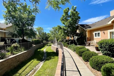 Scenic outdoor pathway with greenery and buildings