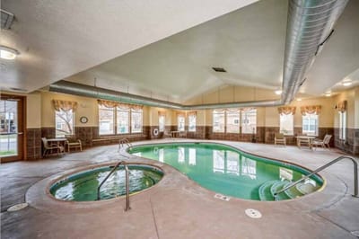 Indoor swimming pool area with seating