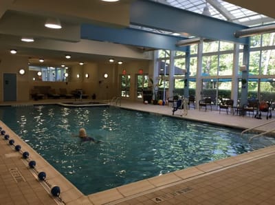 Indoor swimming pool area with seating