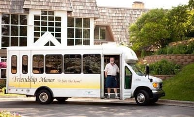 Facility transport bus with a staff member