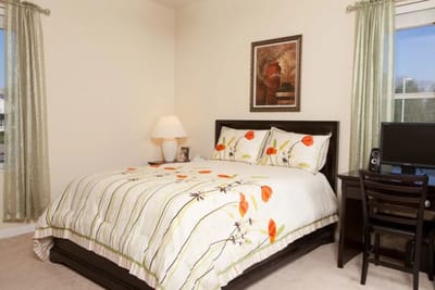 Brightly decorated private resident room with floral bedding