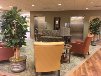 Interior common area with seating and elevators