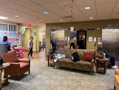 Residents and staff interacting in a warm common area