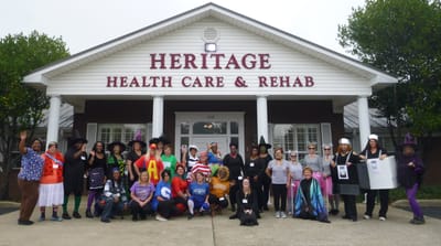 Staff and residents in costumes outside the facility