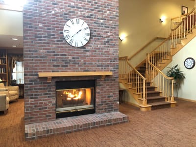 Cozy common area with a fireplace and staircase