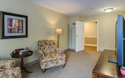 Cozy resident room with chairs and a lamp