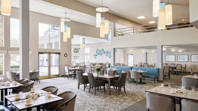 Bright dining room with tables set for breakfast