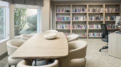 Bright common area with bookshelves and seating
