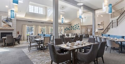 Bright dining room with tables set for residents