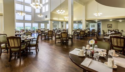 Spacious dining room with tables set for meals
