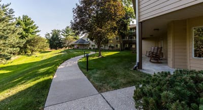 Pathway leading to outdoor green areas with seating
