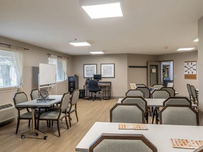 Bright common area with seating and activity tables