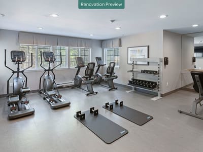 Interior fitness room with exercise equipment and weights