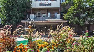 Exterior view of The Courtyard At Lakewood with fountain and flowers