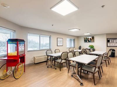 Interior of a common area with tables and a popcorn machine