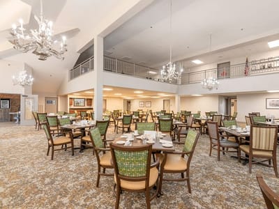 Dining room with elegantly set tables in a bright space
