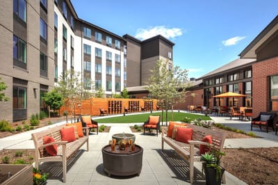 Outdoor seating area with comfortable furniture and green landscaping