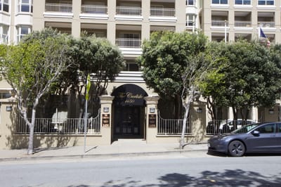 Exterior view of The Carlisle with landscaping and a parked car