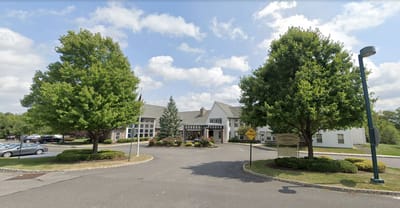 Exterior view of Independence Manor Hunterdon with landscaped entrance