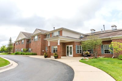 Exterior view of a senior living facility with gardens