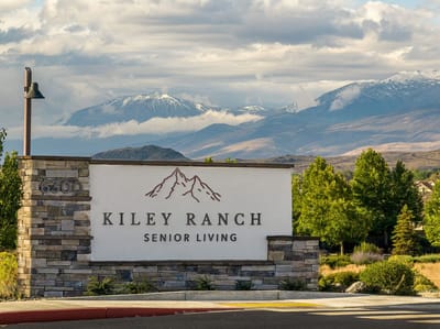 Exterior view of Kiley Ranch Senior Living sign with mountains