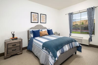 A private resident room featuring a bed and decor