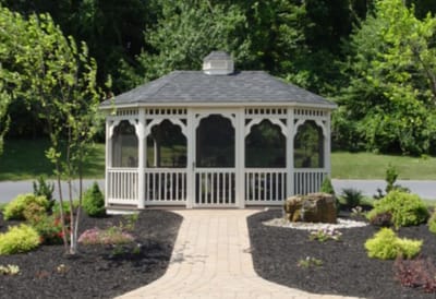 A landscaped gazebo surrounded by flowers