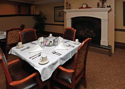 Dining room setup with a fireplace and table settings