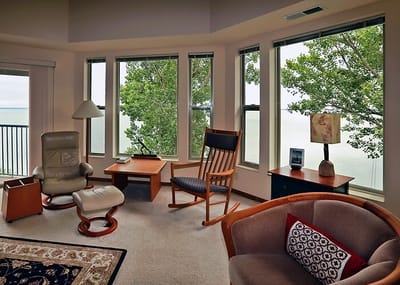 Comfortable seating area with large windows overlooking trees