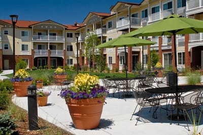 Outdoor view of Lakeview Senior Living with vibrant gardens and seating areas
