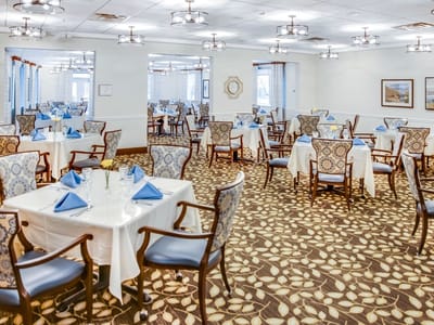 Elegant dining room with tables set for meals