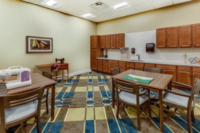 Activity room with tables and a sewing machine
