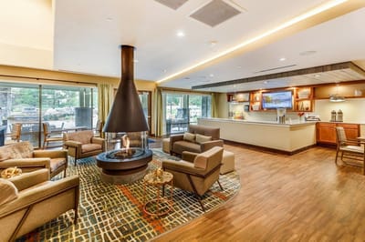 Bright and inviting common area with seating and a fireplace