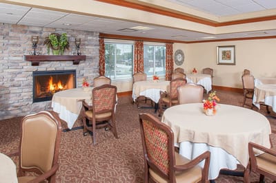 Cozy dining area with tables and fireplace