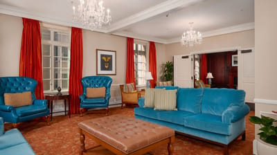 Bright lounge area with blue furniture and chandeliers