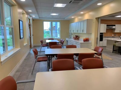 Bright common area with tables and chairs set up