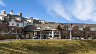 Exterior view of Maple Ridge Retirement Community with flag