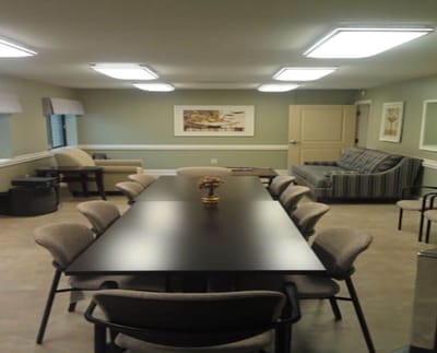 Interior view of a common area with a long table