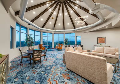 Bright common area with large windows and modern furnishings