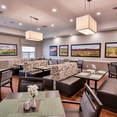 Bright dining area with elegant seating and artwork
