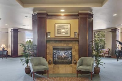 Interior view of a common area with a fireplace and seating